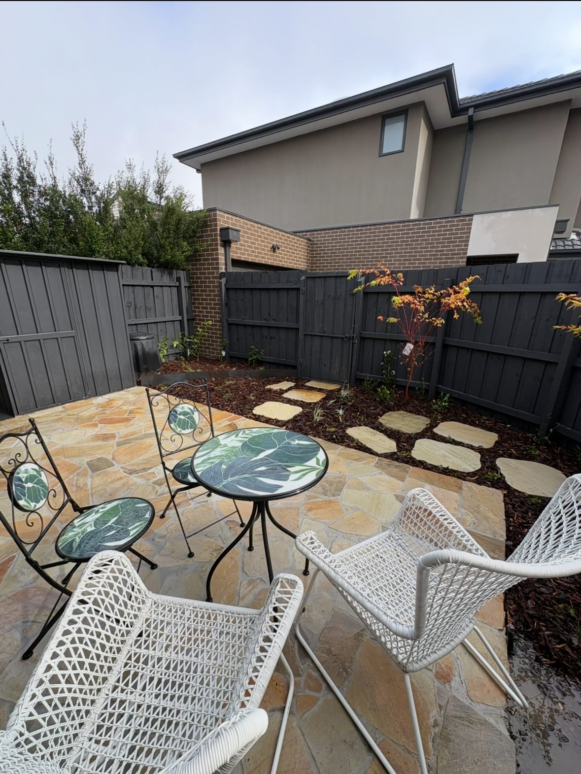 Sandstone courtyard with stepping stones and new planting