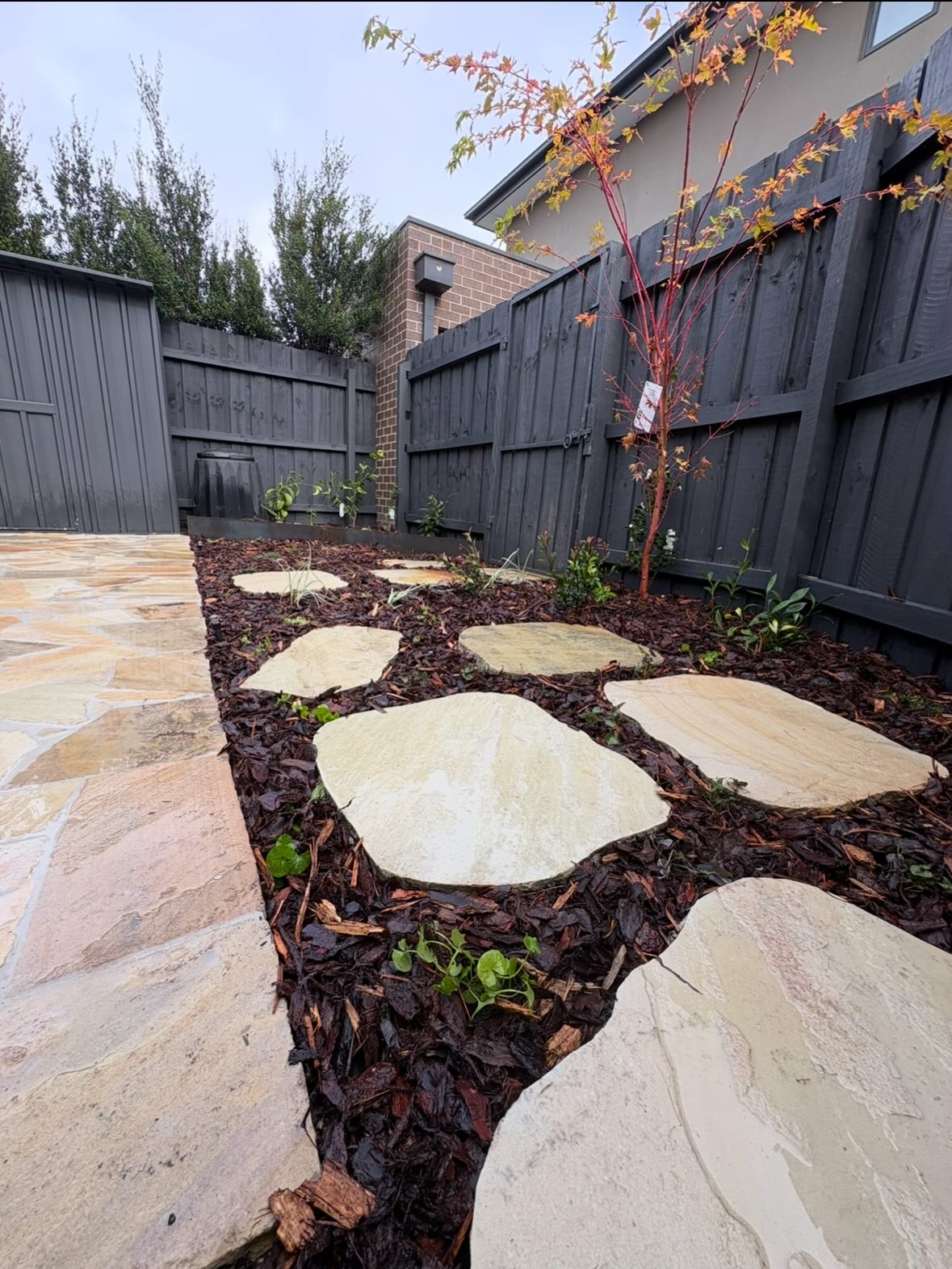 Natural stone stepping path through garden bed