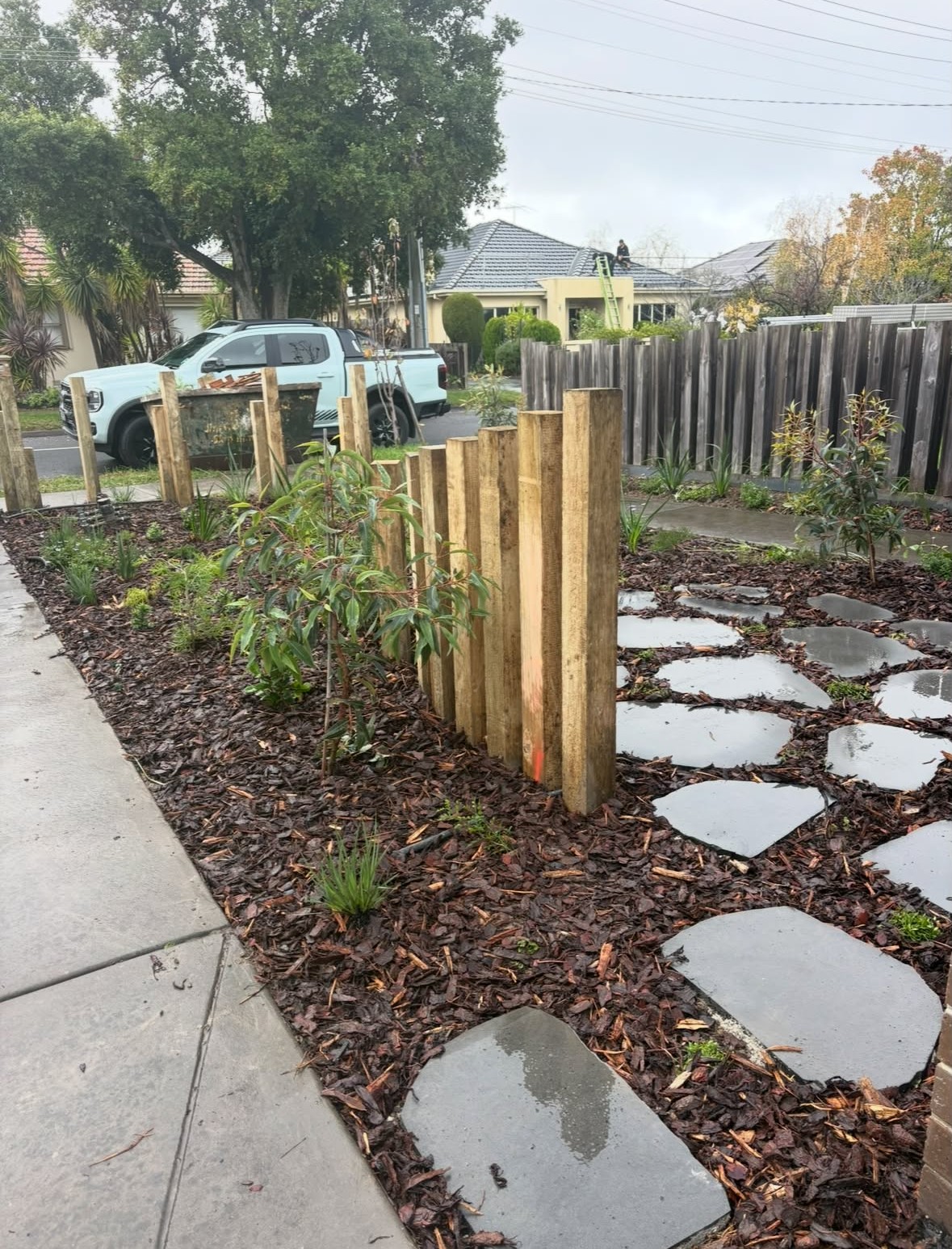 Timber post screening with bluestone steppers and new planting